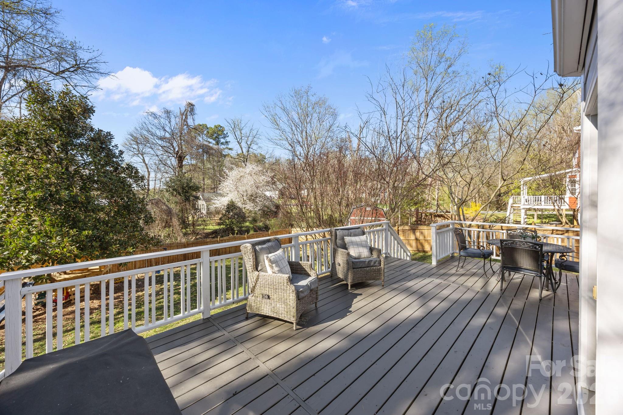 264 Post Oak Avenue Southwest Concord, NC 28025 - Photo 30 of 39 a view of a roof deck with table and chairs with wooden floor and fence