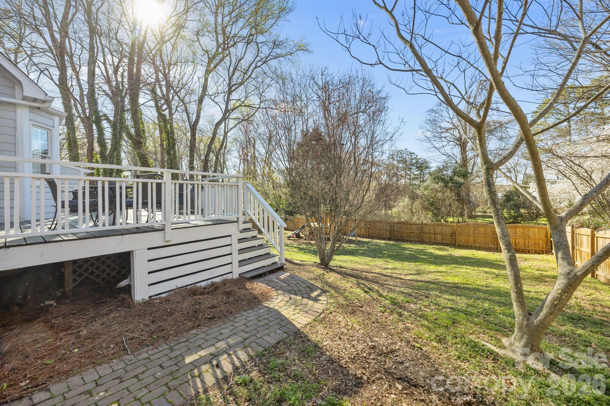 264 Post Oak Avenue Southwest Concord, NC 28025 - Photo 35 of 39 a view of a yard with wooden fence and large trees