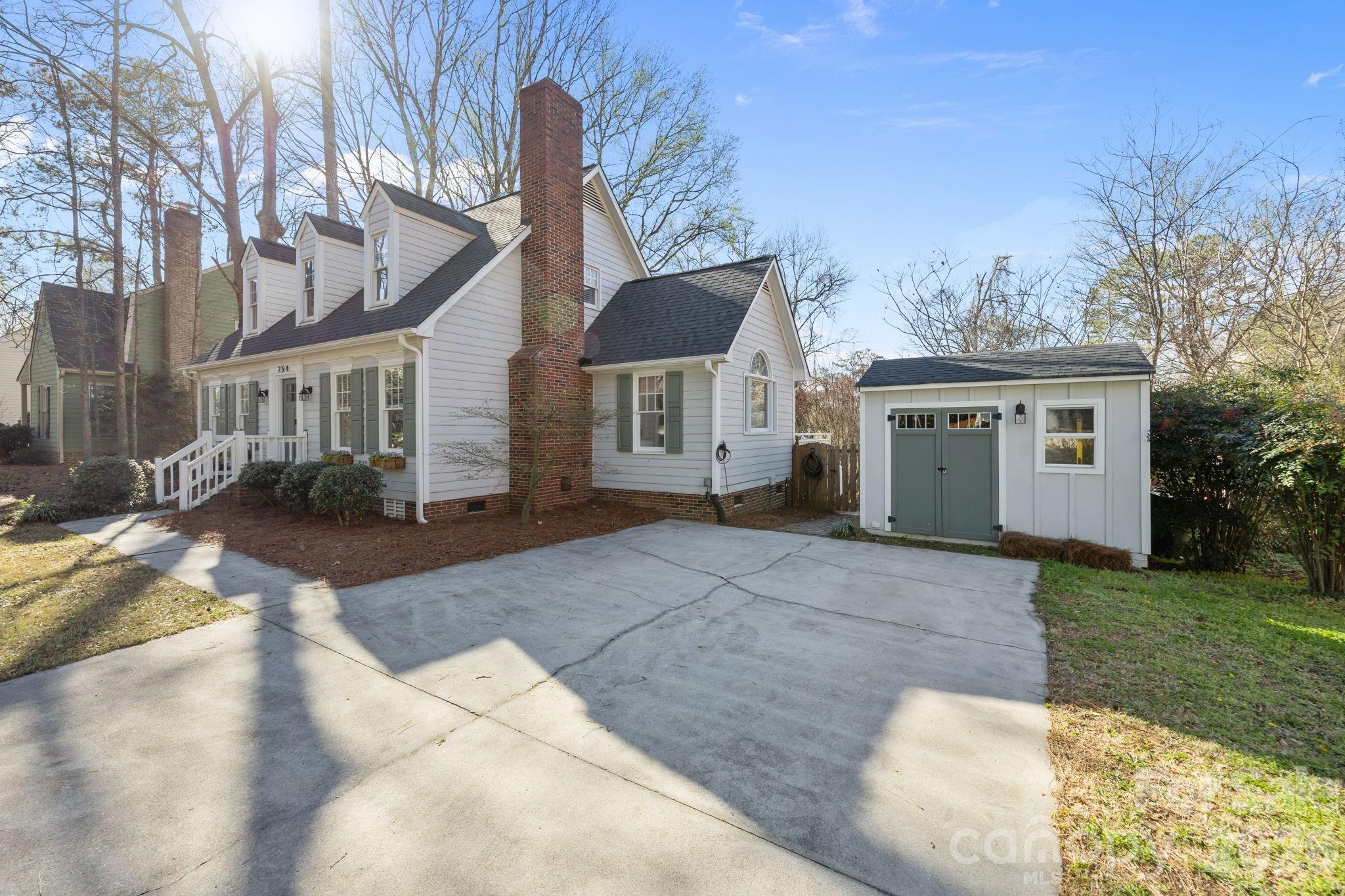264 Post Oak Avenue Southwest Concord, NC 28025 - Photo 39 of 39 a front view of a house with a yard and potted plants