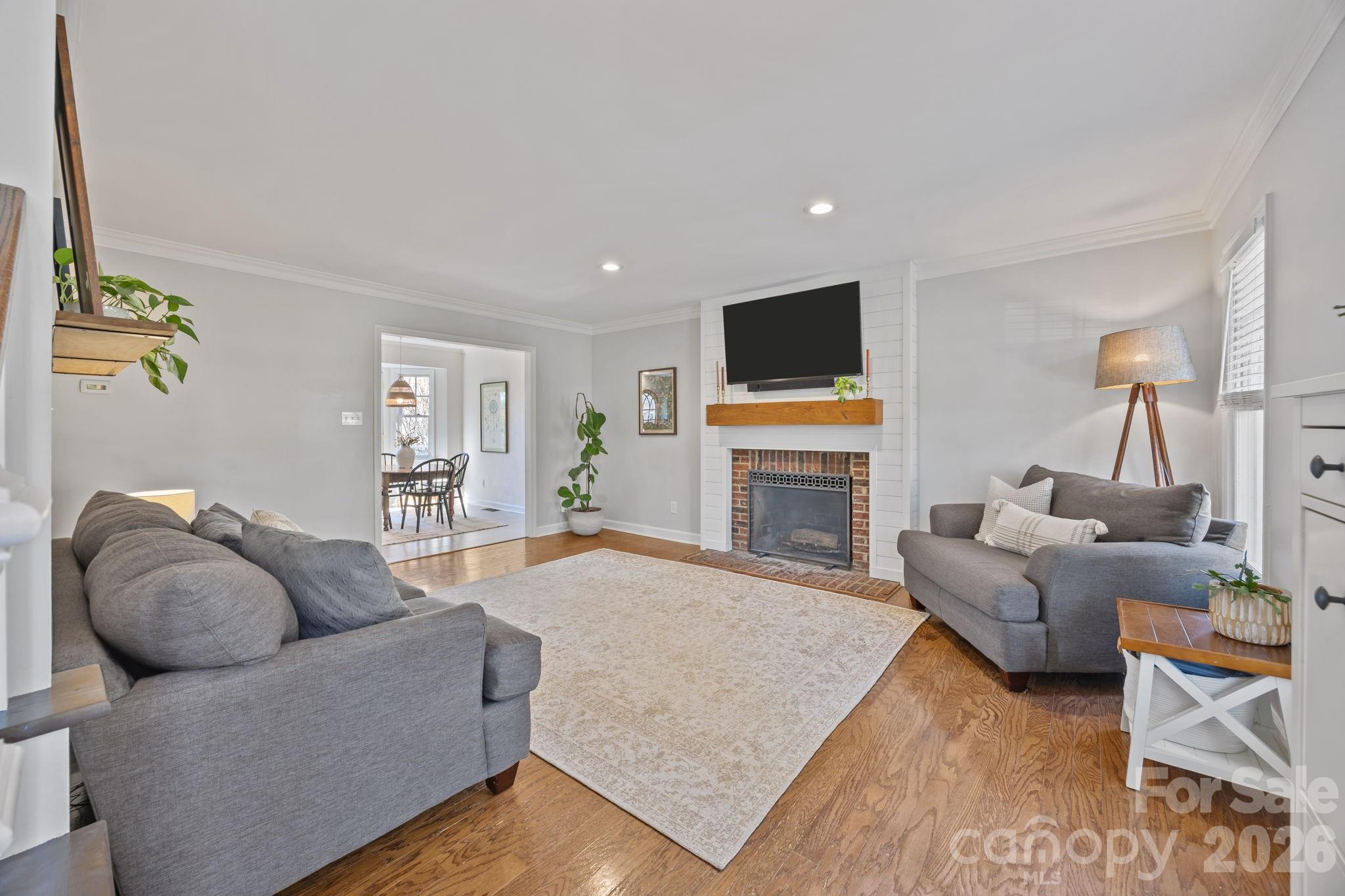 264 Post Oak Avenue Southwest Concord, NC 28025 - Photo 6 of 39 a living room with furniture a flat screen tv and a fireplace