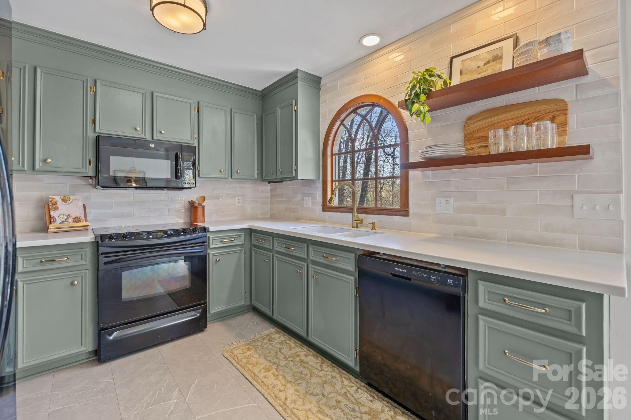 264 Post Oak Avenue Southwest Concord, NC 28025 - Photo 10 of 39 a kitchen with stainless steel appliances granite countertop a stove and a sink