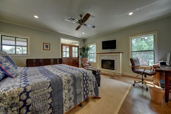 a living room with furniture a chandelier and a fireplace