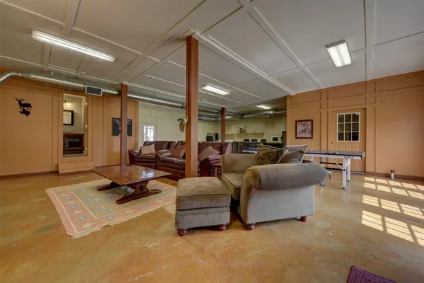 a kitchen with stainless steel appliances granite countertop a stove a sink dishwasher and a refrigerator with wooden floor