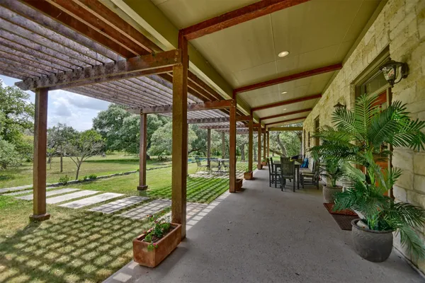 a view of a porch with furniture and garden