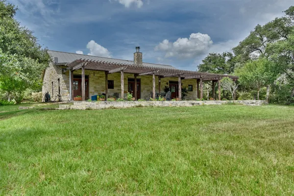 a front view of house with yard outdoor seating and green space