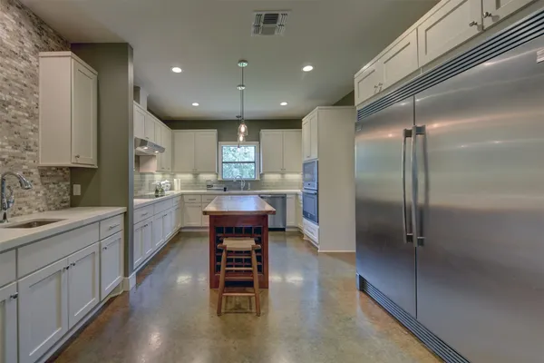 a living room with furniture a chandelier and a flat screen tv