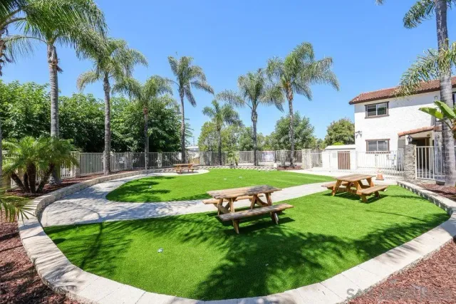 a view of a sitting area with swimming pool and green space