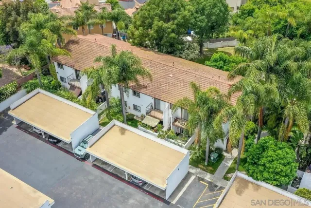 an aerial view of residential house with outdoor space and trees all around