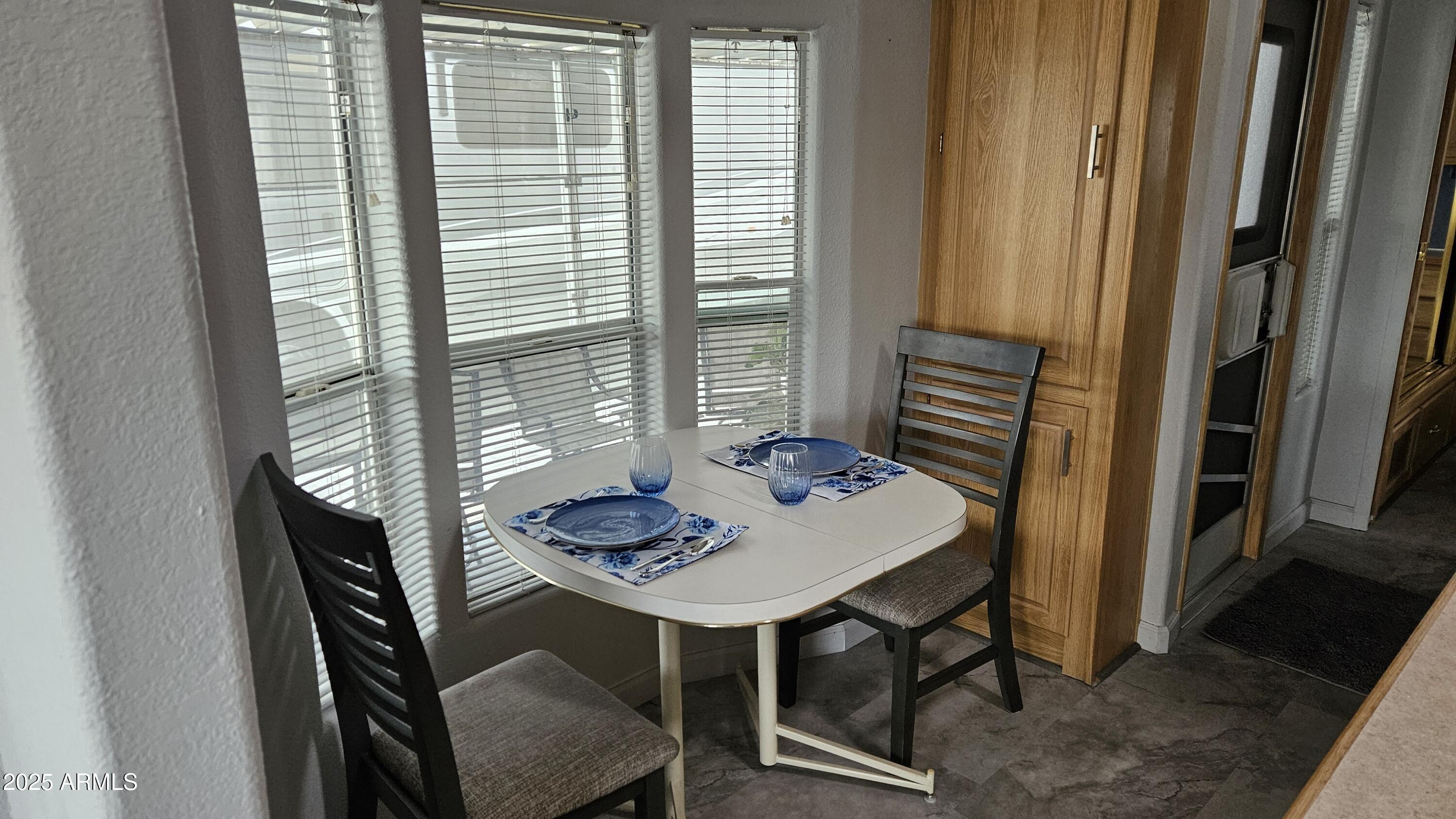 2205 West Klamath Avenue Apache Junction, AZ 85119 - Photo 11 of 36 a table and chairs in a balcony