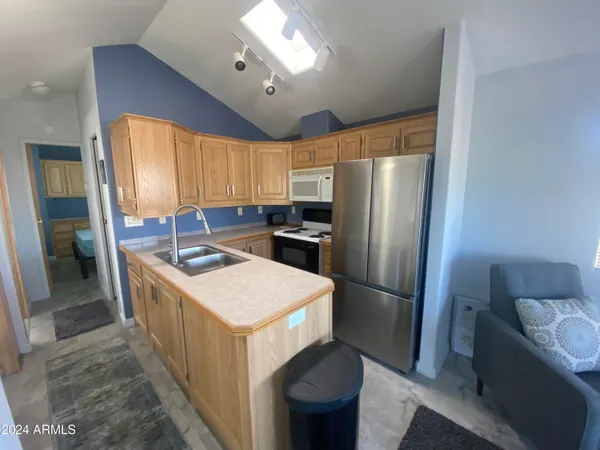 a kitchen with sink stove and cabinets