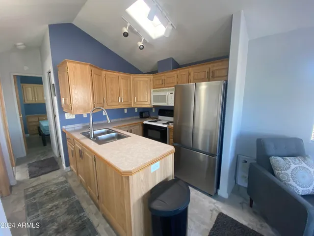 a kitchen with sink stove and cabinets