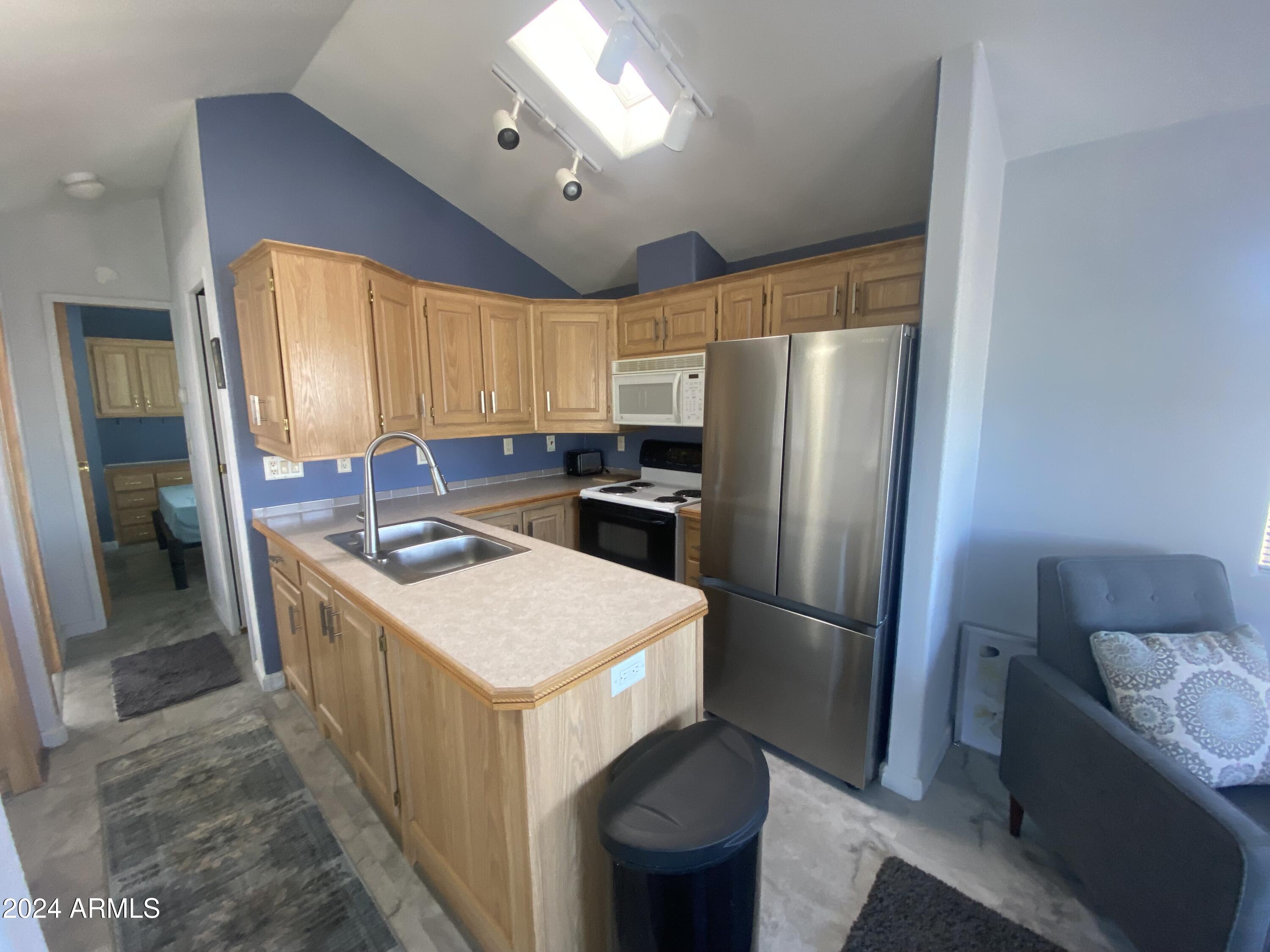 2205 West Klamath Avenue Apache Junction, AZ 85119 - Photo 16 of 36 a kitchen that has a sink stainless steel appliances a refrigerator and a sink