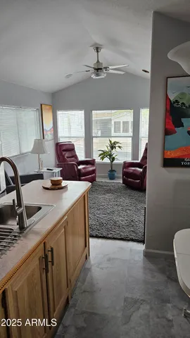 a bedroom with a bed and painting on the wall