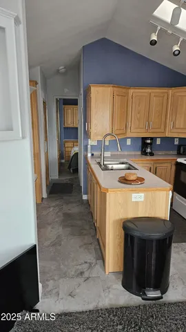 a bathroom with a granite countertop toilet and a shower