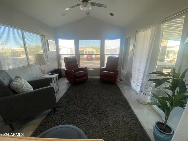 a living room with furniture fireplace and a large window