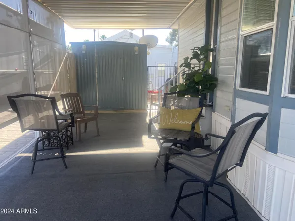 a view of a patio with table and chairs