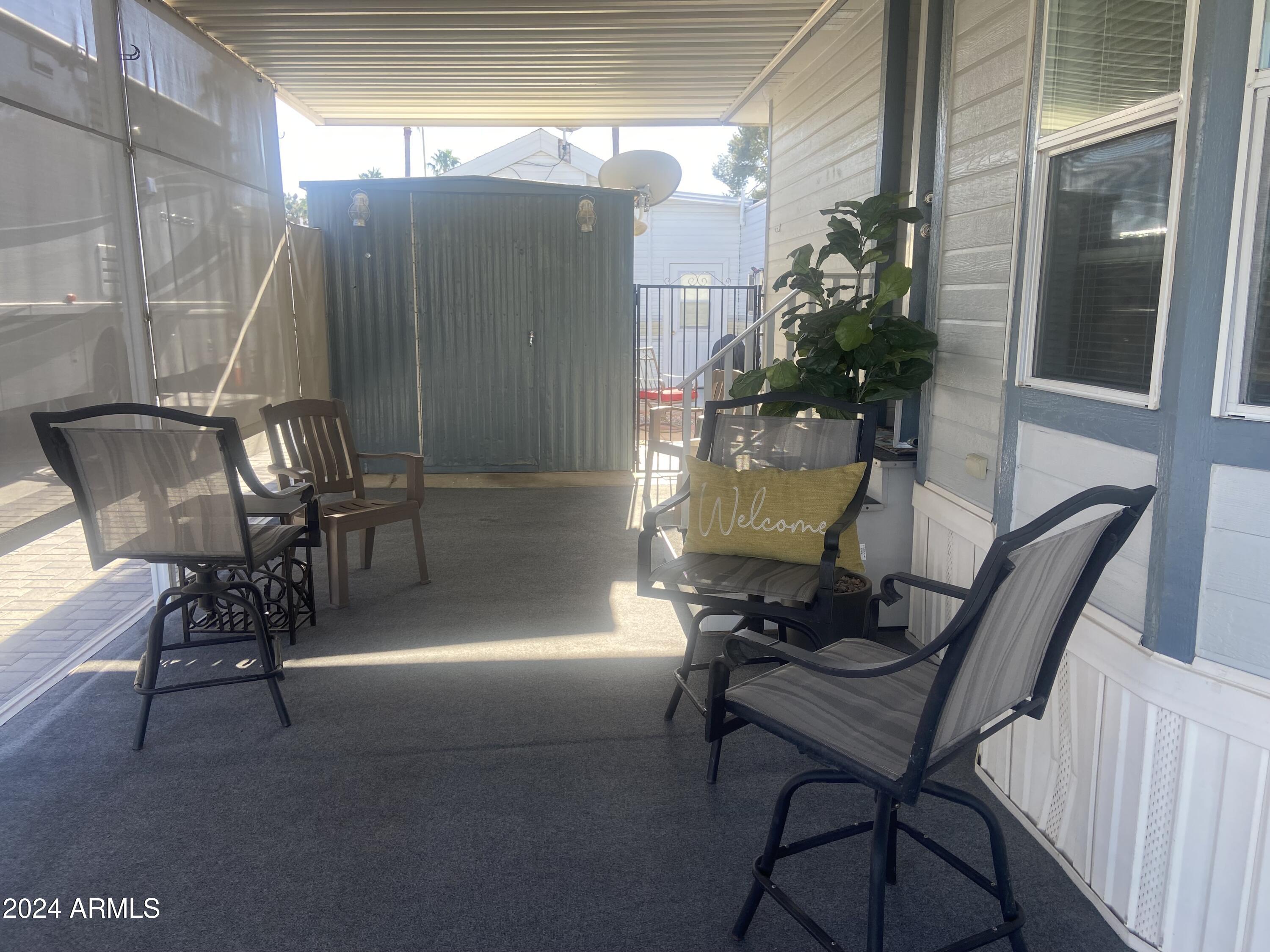 2205 West Klamath Avenue Apache Junction, AZ 85119 - Photo 25 of 36 a view of a porch with furniture and a yard