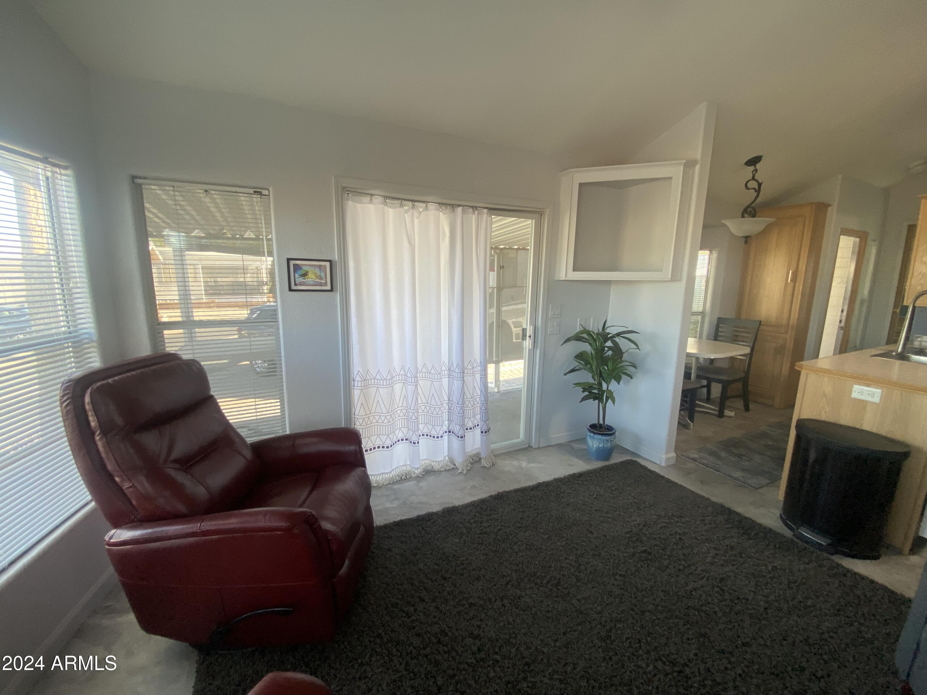 2205 West Klamath Avenue Apache Junction, AZ 85119 - Photo 4 of 36 a living room with furniture and a potted plant