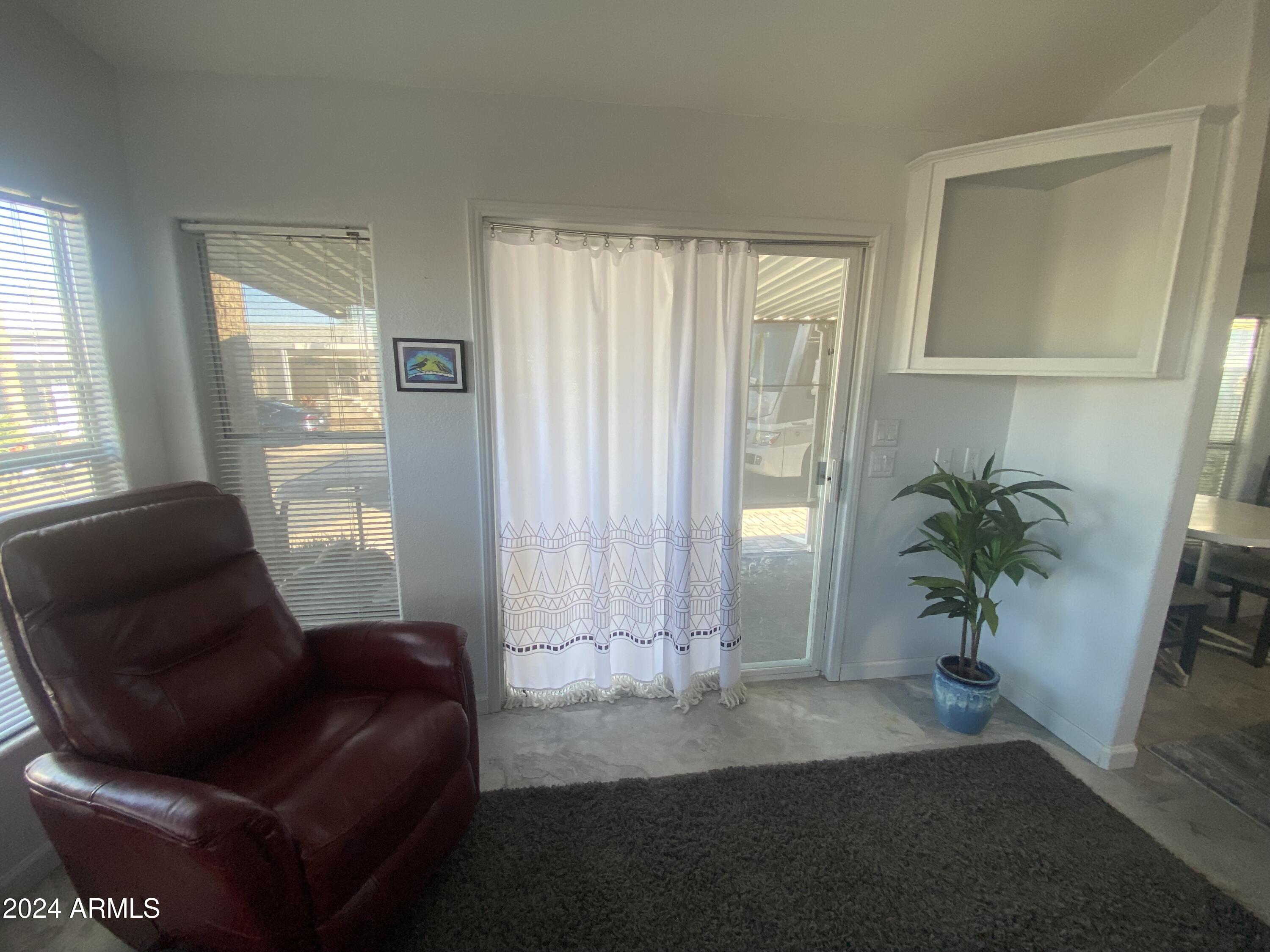 2205 West Klamath Avenue Apache Junction, AZ 85119 - Photo 5 of 36 a living room with furniture and a potted plant