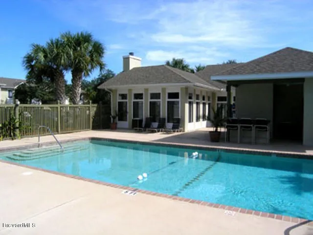a view of a house with swimming pool and a yard