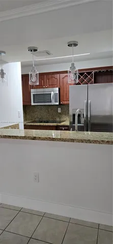 a kitchen with granite countertop cabinets