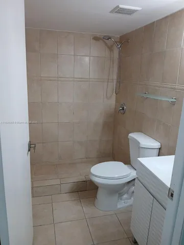 a white toilet sitting next to a bathroom sink