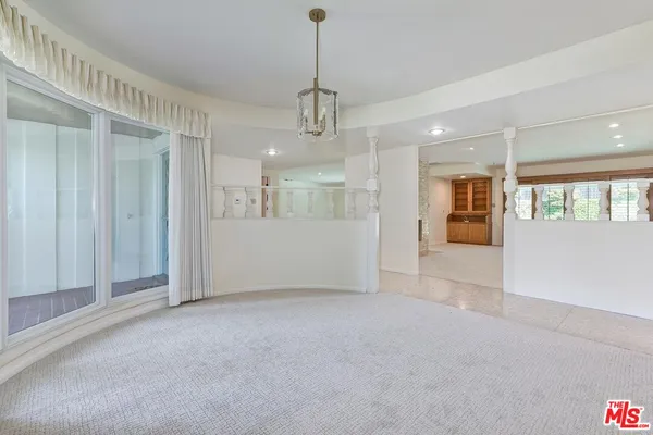 an empty room with furniture and a fireplace