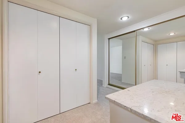 a bathroom with a bathtub shower sink vanity and mirror