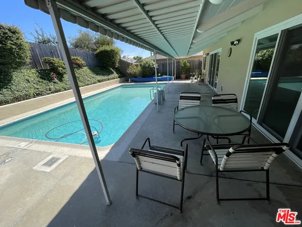 a view of a chairs and table in the balcony