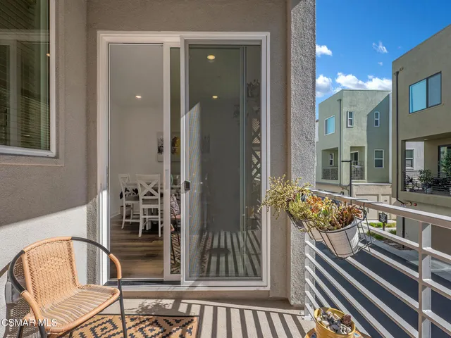 a large white kitchen with a table and chairs