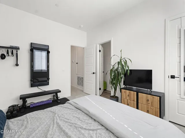 a bedroom with a bed and a table