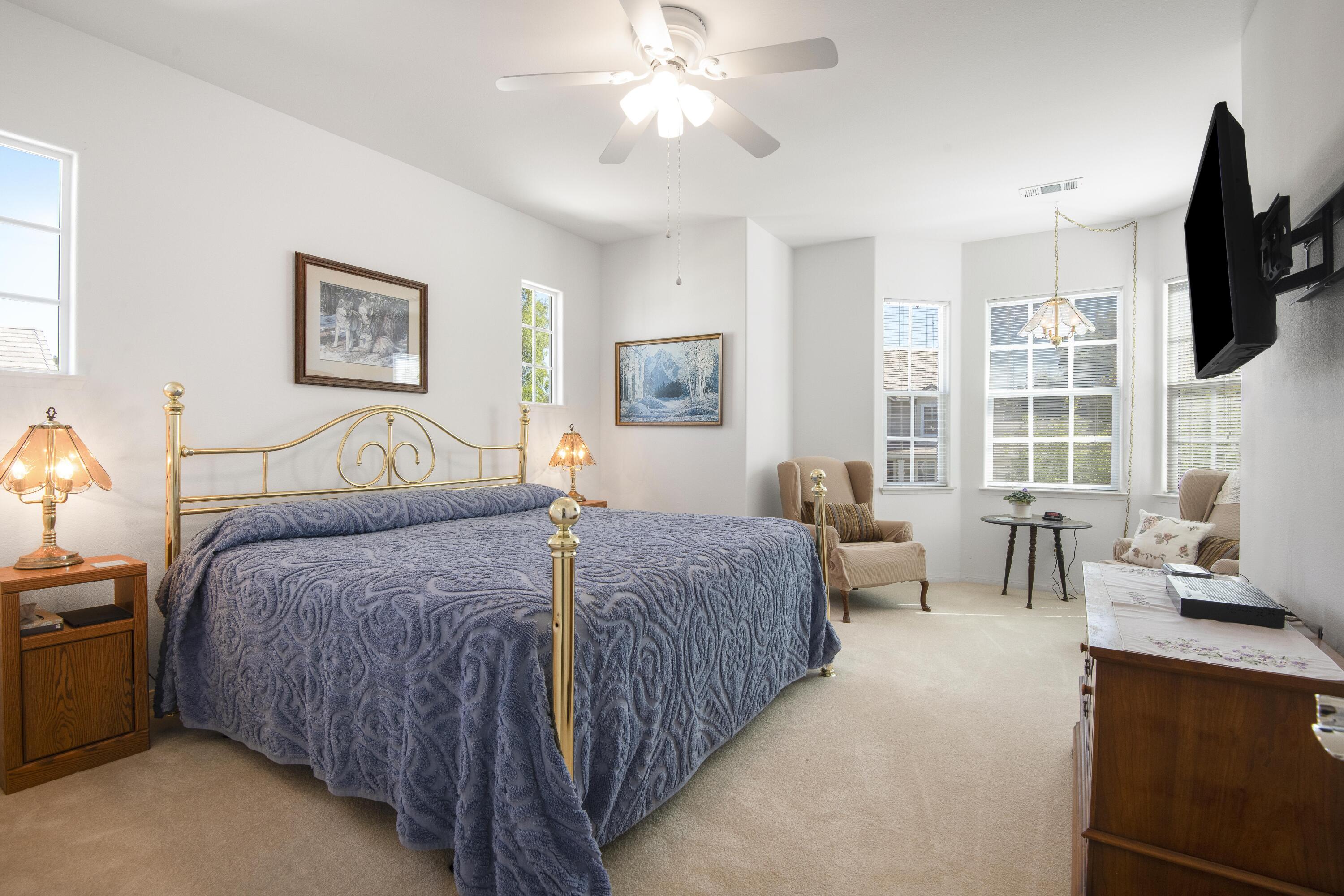 225 Silver Oak Drive Paso Robles, CA 93446 - Photo 11 of 22 a bedroom with a bed a couch and a flat tv screen on dresser