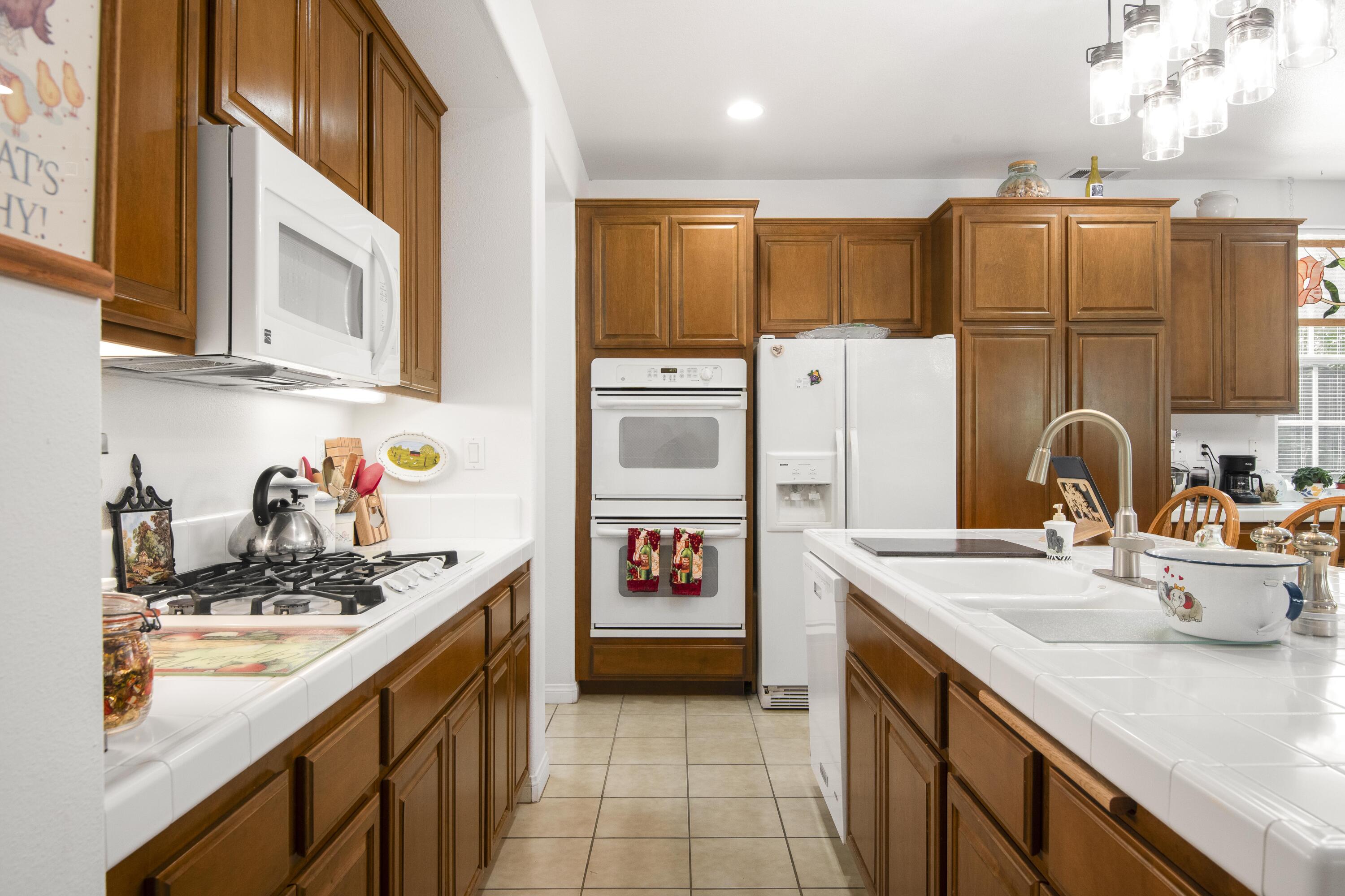 225 Silver Oak Drive Paso Robles, CA 93446 - Photo 4 of 22 a kitchen with stainless steel appliances a sink and a refrigerator
