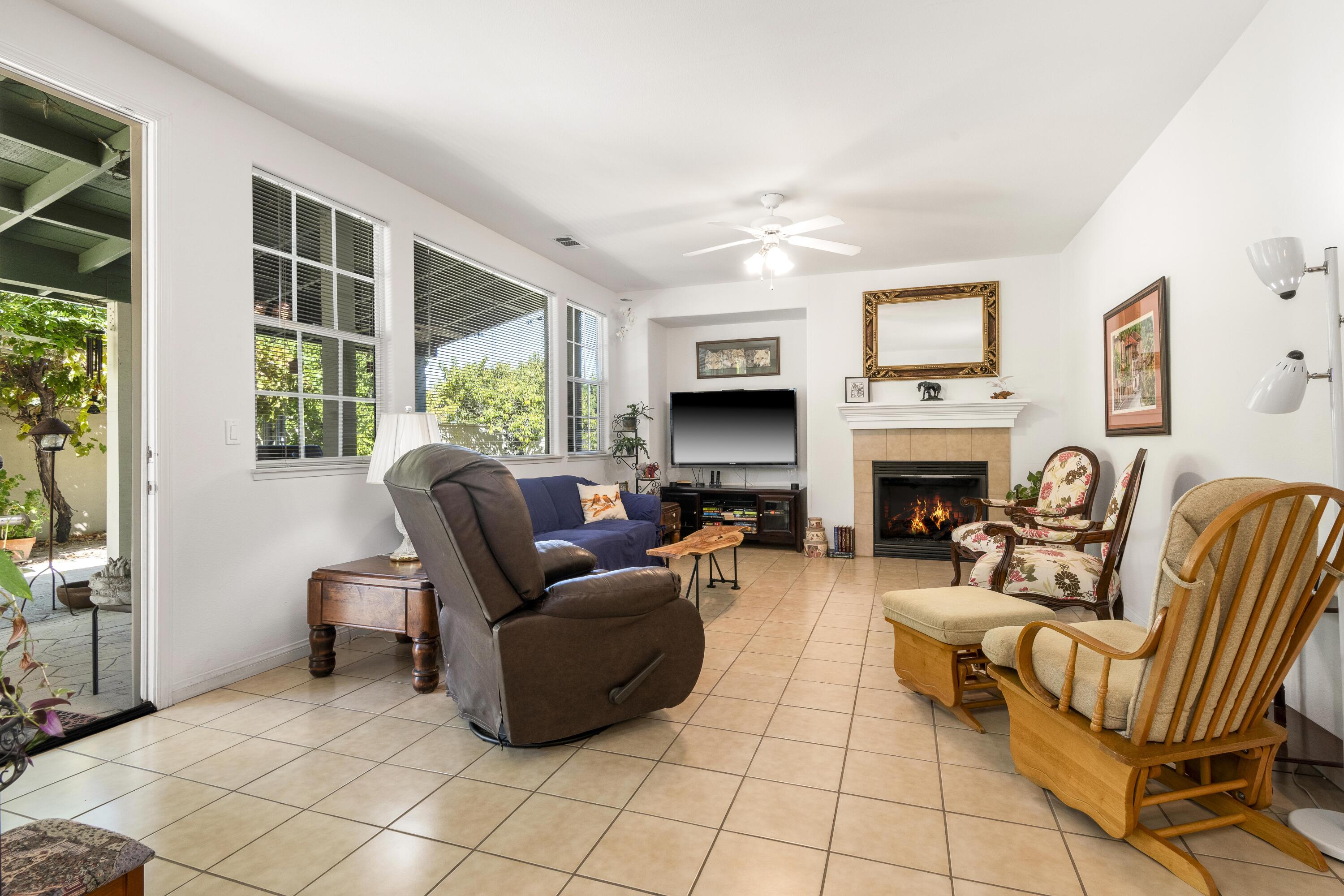 225 Silver Oak Drive Paso Robles, CA 93446 - Photo 8 of 22 a living room with furniture a fireplace and a flat screen tv