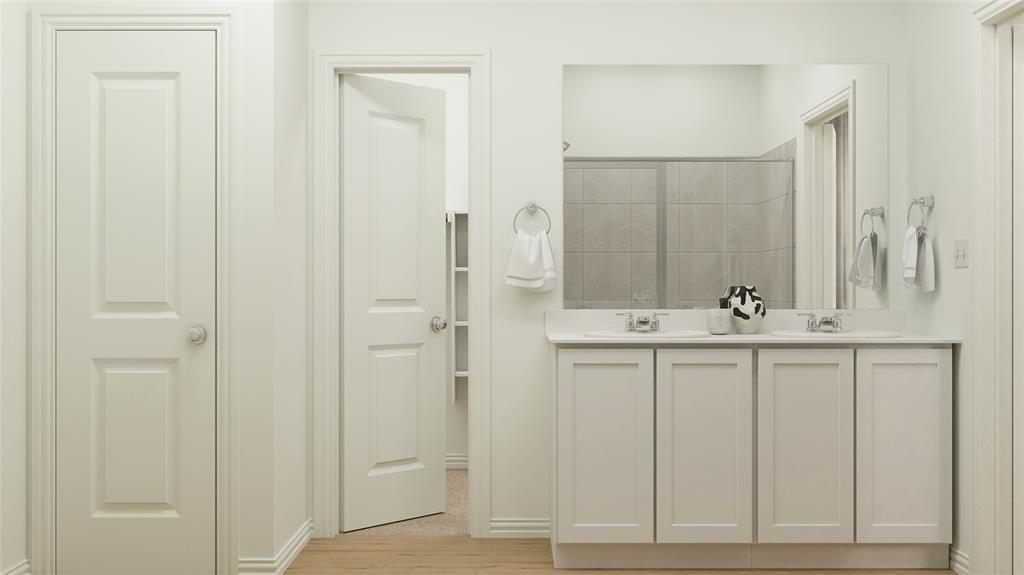 227 Jenkinson Drive Fate, TX 75189 - Photo 13 of 17 a bathroom with a sink and a mirror