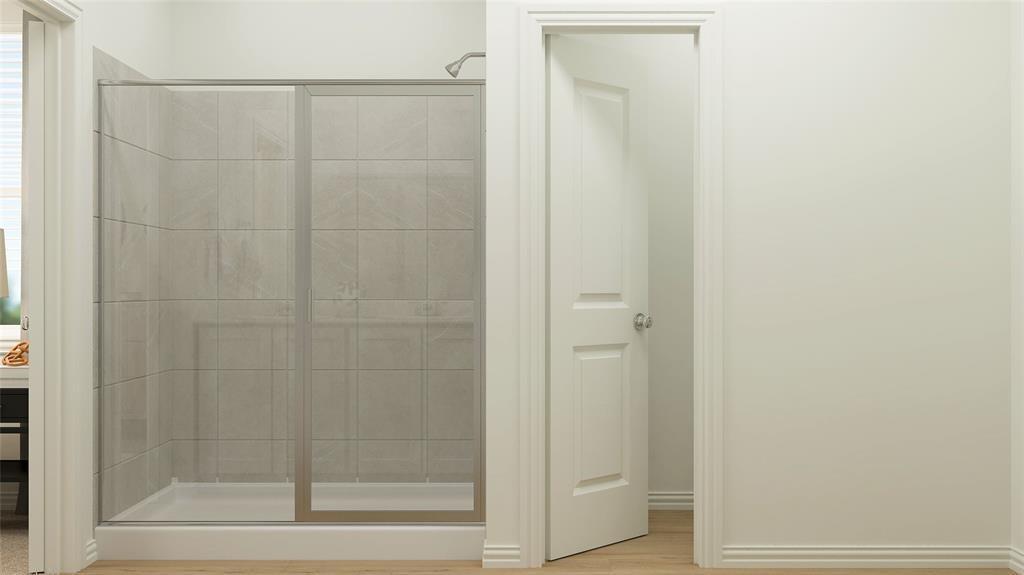 227 Jenkinson Drive Fate, TX 75189 - Photo 14 of 17 a bathroom with a glass shower door