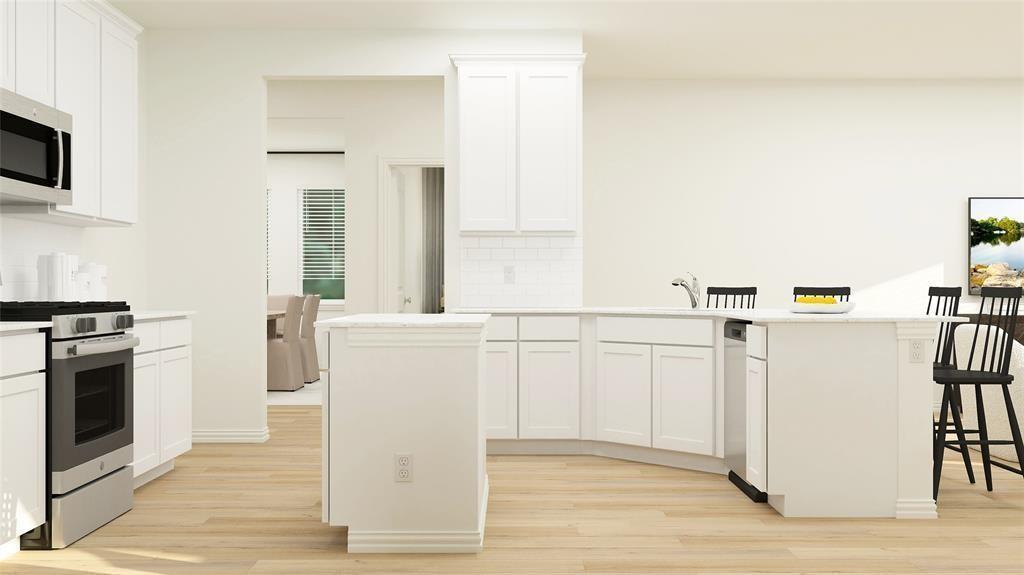 227 Jenkinson Drive Fate, TX 75189 - Photo 5 of 17 a kitchen with white cabinets and white appliances