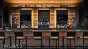 a living room with lots of furniture and kitchen view