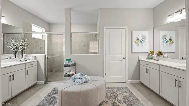 a en suite bathroom with a double vanity sink and a mirror