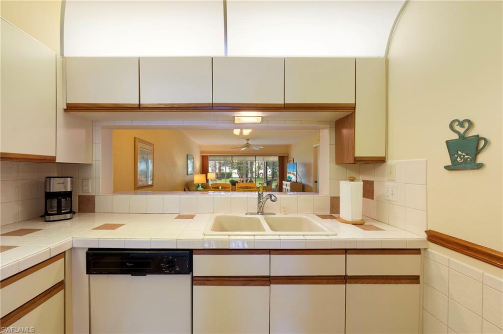 1231 Commonwealth Circle, Unit Q103 Naples, FL 34116 - Photo 5 of 22 Kitchen with pass-thru access to larger dining area