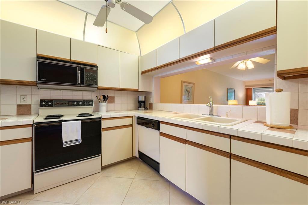 1231 Commonwealth Circle, Unit Q103 Naples, FL 34116 - Photo 6 of 22 Tiled entry and kitchen area