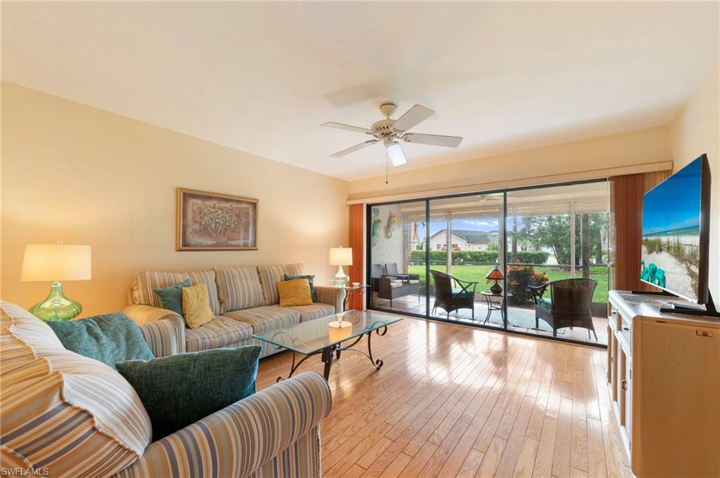 1231 Commonwealth Circle, Unit Q103 Naples, FL 34116 - Photo 10 of 22 Living area with slider access to lanai