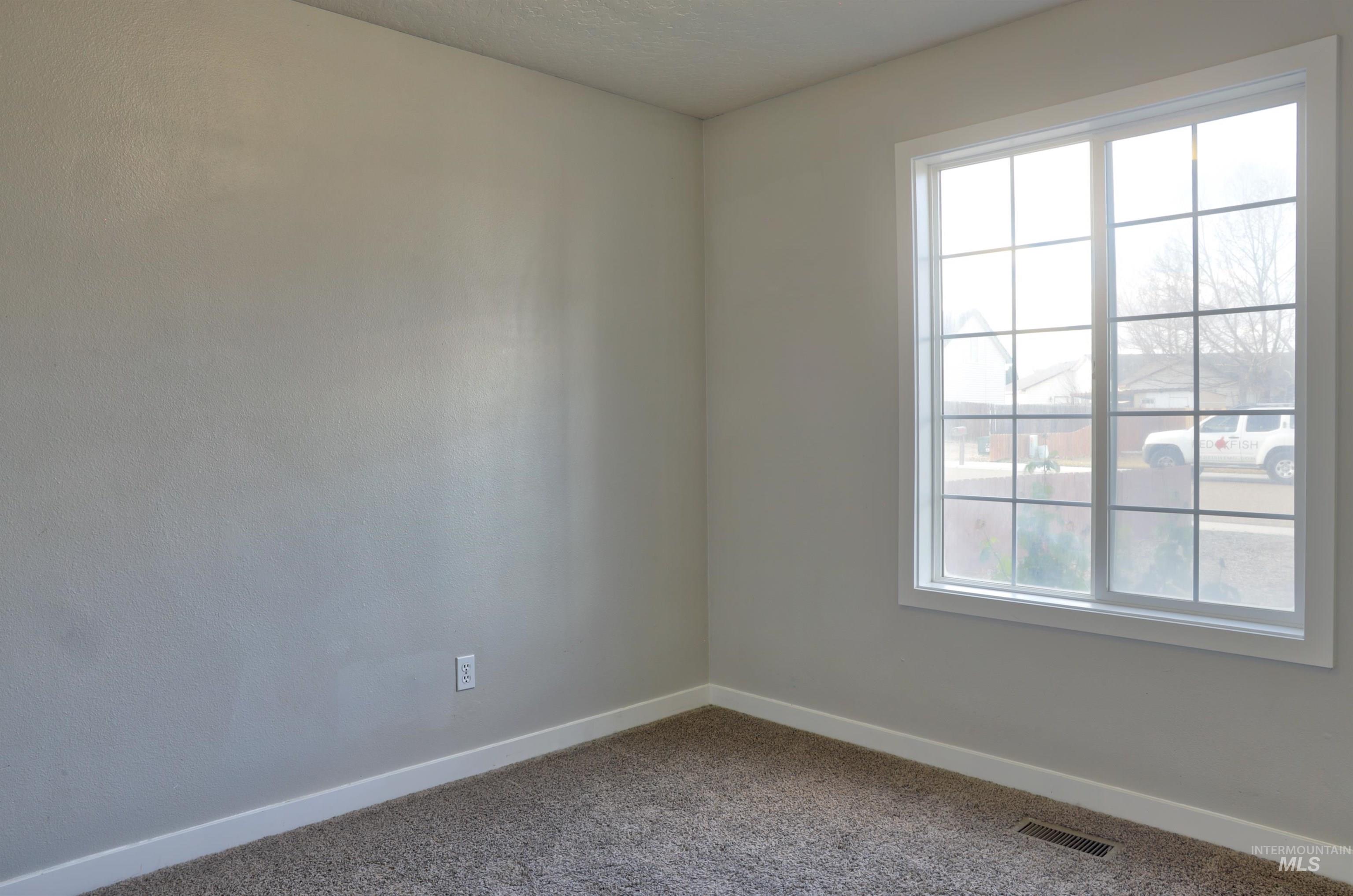 4911 Buffalo Grass Avenue Caldwell, ID 83607 - Photo 10 of 15 Empty room with baseboards and carpet
