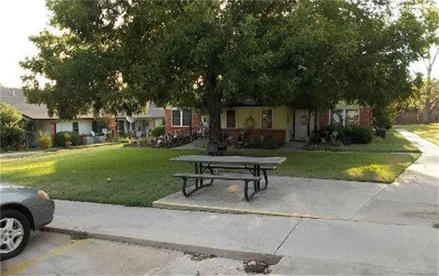 a swimming pool with outdoor seating and yard