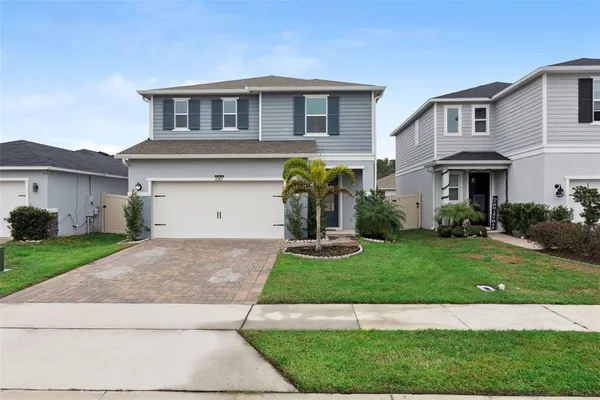 a front view of a house with a yard and garage