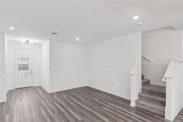 a view of a room with wooden floor and stairs
