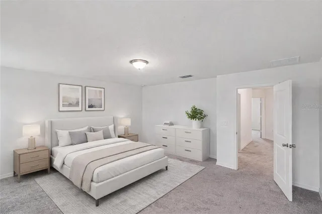 a bedroom with a bed and a painting on the wall