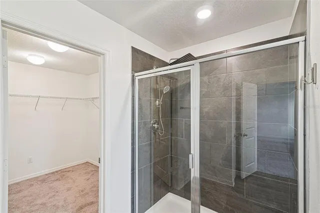 a bathroom with a glass shower door