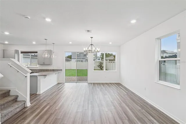 a large kitchen with kitchen island a large window and stainless steel appliances