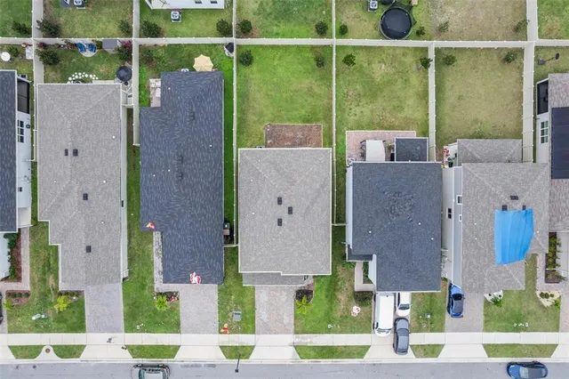 an aerial view of a house with a garden and plants